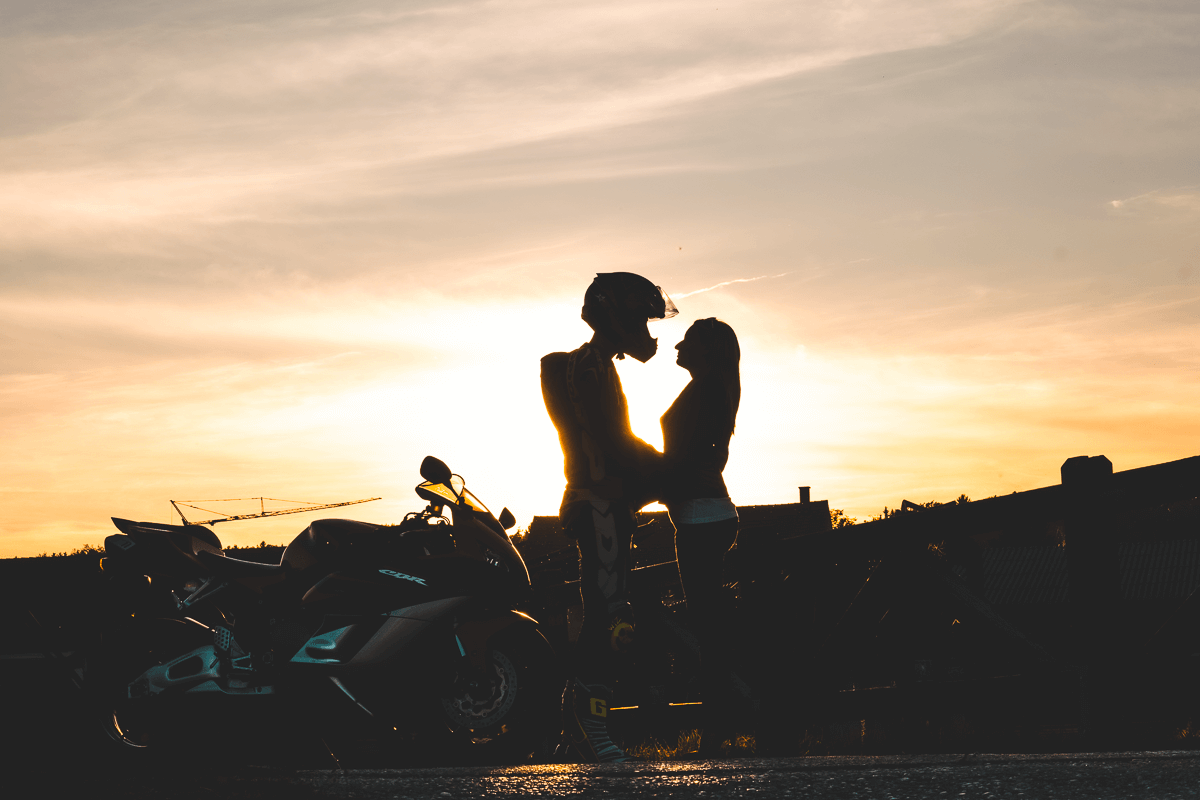 Motorradfahrer und Freundin im Sonnenuntergang